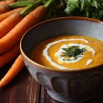 Eine Schale Karottencremesuppe mit Pesto Topping